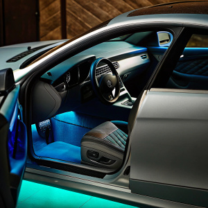 Next-gen Mercedes-Benz E63 AMG Coupe concept. Detailed shots of car's sleek gray body, green and red accents, interior design, and aerodynamic panels.