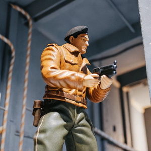 B.J. Blazkowicz, main character from Wolfenstein II: The New Colossus, standing in front of a dimly lit, industrial background. Wearing a brown leather jacket, olive green pants, and a beret.