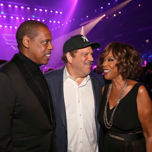 Jay Z, Harvey Weinstein, and Gayle King at the MTV Video Music Awards. Purple stage background, flashing lights