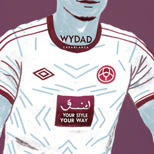 Digital illustration of a soccer jersey for Wydad Casablanca. Predominantly white with red accents, featuring intricate geometric patterns and the club's logo in Arabic script. Close-up of an athlete's face, with text in Arabic and 'Your Style Your Way' beneath.