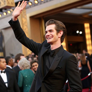 Andrew Garfield, smiling and waving, at the Oscars. Dapper black suit, standing out in the crowd of celebrities.