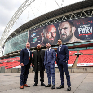 Brad Jacobs, Tyson Fury, Paul Dempsey, and Fury Whyte at a press conference. Wembley Stadium, London. Standing in front of a large Tyson Fury poster