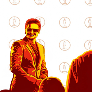 Jeremy Renner, dressed in a gray suit, smiling warmly. Wearing sunglasses. Standing at an event with Film Independent Spirit Awards logos.