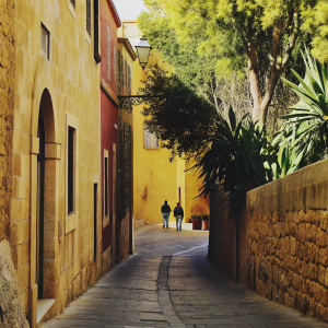 Medieval street in Mdina, Malta. Stone buildings with warm tones. Quiet cobblestone road.
