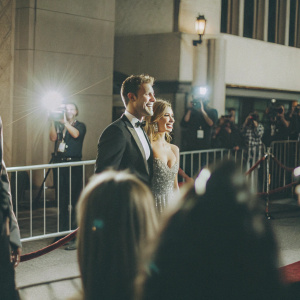 Justin Hartley and Isabella Justice Hartley attending a Hollywood premiere. Red carpet scene, flashing lights and paparazzi.