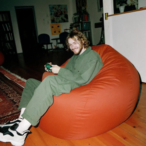 Felix Arvid Ulf Kjellberg, known as PewDiePie, in casual attire. Sitting on a bean bag chair in his home studio, with a mischievous grin.
