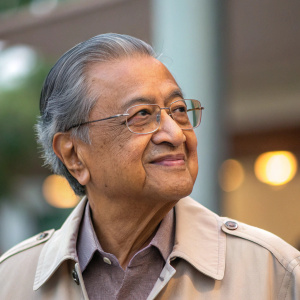 Close-up candid shot of Tun Dr. Mahathir Mohamad. Wearing casual attire, thoughtful expression.