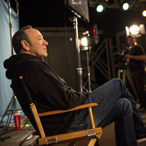 Kevin Spacey in casual attire. Dark jeans and black hoodie. Onset of a film set.