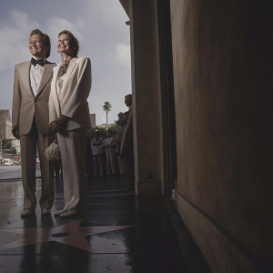 Conan O'Brien and Peggy Colson at the Hollywood Walk of Fame unveiling. Formal wear, smiling, against a bright, sunny backdrop with passing tourists