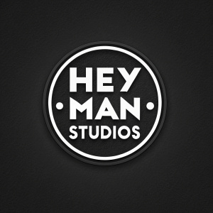Hey Man Studios logo, sleek and minimalist design. Oval shape enclosing bold font. White on black. Digital artwork with contemporary vibe.