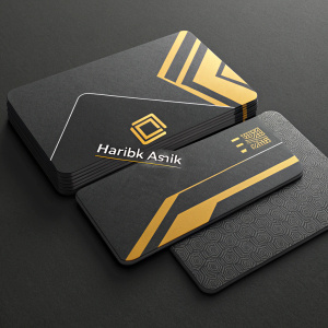 Designing modern business cards for Haribik Ashik. Dark grey cards with yellow accents. Distinctive logo prominently displayed. Contact information arranged clearly. Dark surface background for high contrast and clarity. Contemporary and professional aesthetic.