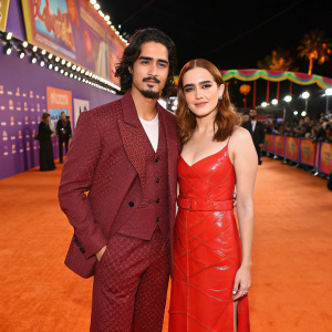 Avan Jogia and Zoey Deutch at award ceremony. Orange carpet area with vibrant background