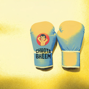 Boxing gloves featuring the beloved animated character Chhota Bheem. Vibrant blue and orange colors. Bold logo with character name in playful font. Chhota Bheem smiling and in action pose.