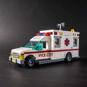 A custom-built Lego ambulance replica, featuring a distinctive Vice City logo. Displayed on a dark, themed backdrop