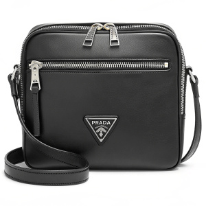 A sleek black Prada leather crossbody bag. Features a prominent triangular logo with brand name. It has a zippered main compartment and a comfortable strap.
