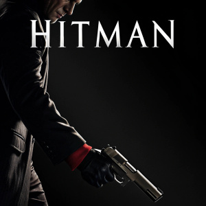 Promotional poster for 'Hitman'. Predominantly black background with close-up of a hand gripping a gun. The character's silhouette and torso are partially visible. Text 'Hitman' in bold white letters centered at the top. Dark and dramatic tone.