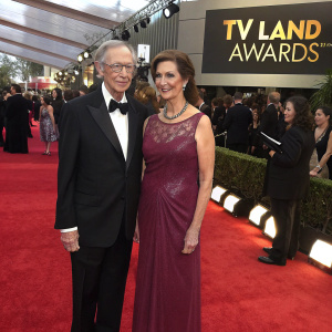 Bernie Kopell and Catrina Honadle at the Met Gala. Black-tie event with red carpet. TV Land Awards logo in background