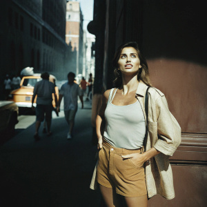 Ana De Armas standing on a busy street. Wearing casual outfit. Background is urban and lively.