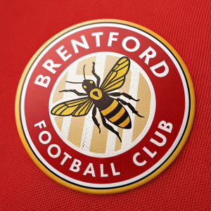 Brentford FC's emblem features a dynamic bee centrally positioned on a vivid red background. The bee's body showcases intricate black and yellow stripes. The club's name 'Brentford Football Club' encircles the emblem in bold, modern font, evoking a strong, sporty identity.