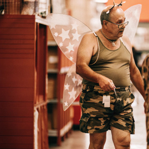 People of Walmart.  Camo fairy man.  Camo fairy wing, camo shorts, camo tank top.  Male, 65 years old and balding 