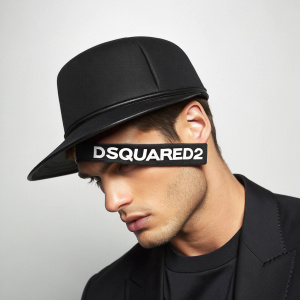 A stylish flat-front black hat featuring bold DSQUARED2 branding. The hat is prominently displayed on a sleek, minimalist background.