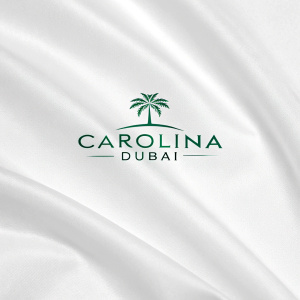 Carolina Dubai logo featuring modern green font against white backdrop. Text reads 'Dubai'