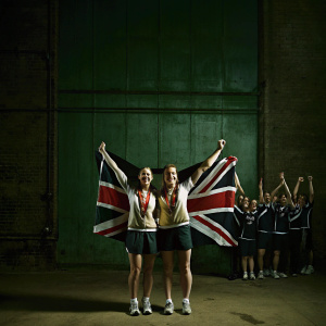 Laura Weightman and Jessica Judd, British track athletes, celebrating their victories in a victory lane post-race. Crowd cheering in background.