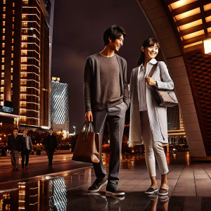 Kim Soo-hyun and Angelababy at a tech event. Wearing casual outfits. Modern cityscape background.