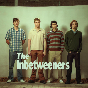 Promotional poster for 'The Inbetweeners'. Four young men standing together against plain white backdrop. Show title 'The Inbetweeners' written below in bold font.