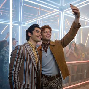 Rob Raco and KJ Apa at the Snapchat launch party. Neon lights and excited crowd in the background.