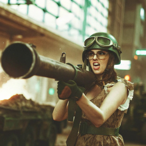 Tank Girl, a determined and rebellious heroine, wielding a massive weapon. She is dressed in combat gear, green helmet, and goggles. The scene shifts to a futuristic urban wasteland with neon lights and debris.