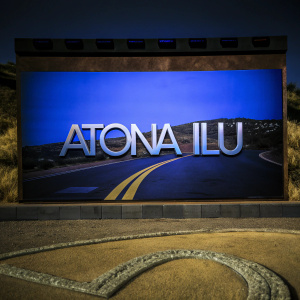 Digital artwork featuring a sleek, modern logo for 'Atona Ilu', a creative studio. The design includes a road-like graphic element and a stylish, contemporary aesthetic on a dark backdrop.