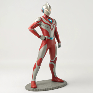 3D render of Ultraman Hayata figurine. Made of smooth, clay-like material. Red and grey color scheme. Confident stance and detailed sculpting. Shown against plain background.
