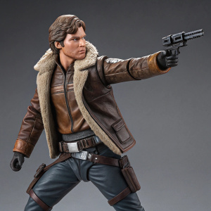 Han Solo action figure. Standing in a fighting pose with a blaster. Detailed with a brown leather jacket, belt, and fur-lined collar. Gray studio background.