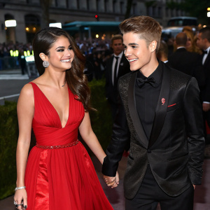 Selena Gomez and Justin Bieber at the Met Gala, smiling and holding hands on a crowded street