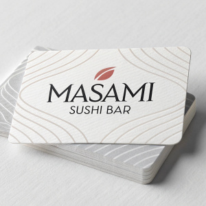 Business cards for Masami Sushi Bar. Sleek design on glossy paper. Logo and text in modern font style. White background with subtle texture. Neutral gray highlights.