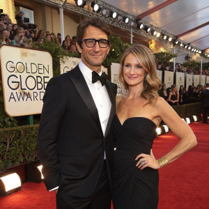 Jonathan LaPaglia and Ursula Brooks at the Golden Globe Awards. Formal attire, posing for a glamourous red carpet photo.