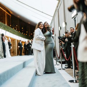 Chloe Olsen and Kathy Ireland at a bustling awards ceremony. Flashing cameras, celebrities in the background.