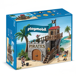 Box featuring Playmobil Pirates playset. Blue exterior, detailed illustration showing wooden fort, palm tree, and beach. Playmobil logo