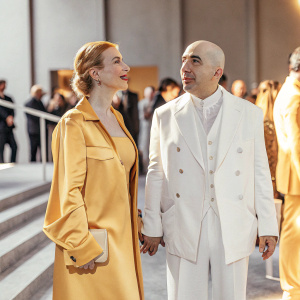 Julia Milner and Yuri Milner at the Breakthrough Prize Ceremony, dressed in elegant attire. Crowded hall with various celebrities.
