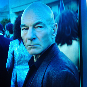 Patrick Stewart, star trek actor, bald head, intense look. Close-up photo from a glitzy award ceremony.