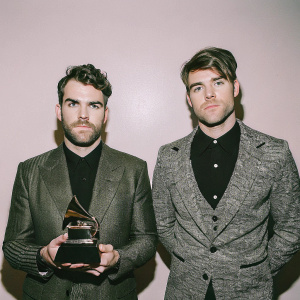 Alex Pall and Andrew Taggart of The Chainsmokers. Black and white photo. Formal attire, posing backstage at the Grammys