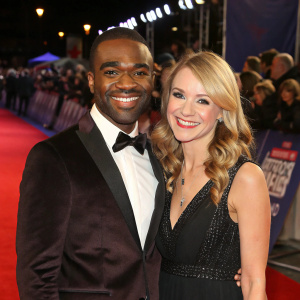 Ore Oduba and Portia Oduba, gracing the stage at the British Comedy Awards. Smiling warmly. Red carpet ambiance with spectators
