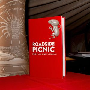 Book cover design for 'Roadside Picnic' by Boris and Arkady Strugatsky. A sleek mouse-like alien creature in mid-jump. Title and author names prominently displayed in bold white font. Dark, moody background with intricate white line art.