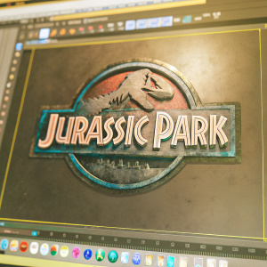 3D render of the Jurassic Park logo with a vintage, weathered look. Set against a sleek, modern software interface. Black backdrop.