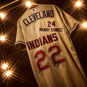 Majestic replica Cleveland Indians jersey featuring #24 Manny Ramirez. Bright stadium lights in background.