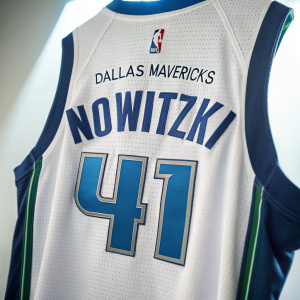 Close-up of a Dallas Mavericks jersey with the number 41 and the name Nowitzki. The jersey is displayed against a bright, empty backdrop.