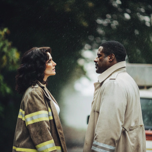 Melissa Ponzio as Donna Robbins and Eamonn Walker as Chief Wallace Boden in intense scene from 'Chicago Fire'. Dark, dramatic backdrop. Both actors facing each other, serious expressions.