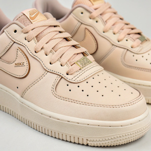 Classic Nike Air Force 1 sneakers, beige color. Logo on side, laces matching, detailed perforations
