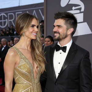 Karen Martinez and Juanes, at the GRAMMY Awards. Karen in a dazzling golden dress, Juanes in a tuxedo. They are standing in front of a crowd, posing for a candid moment.